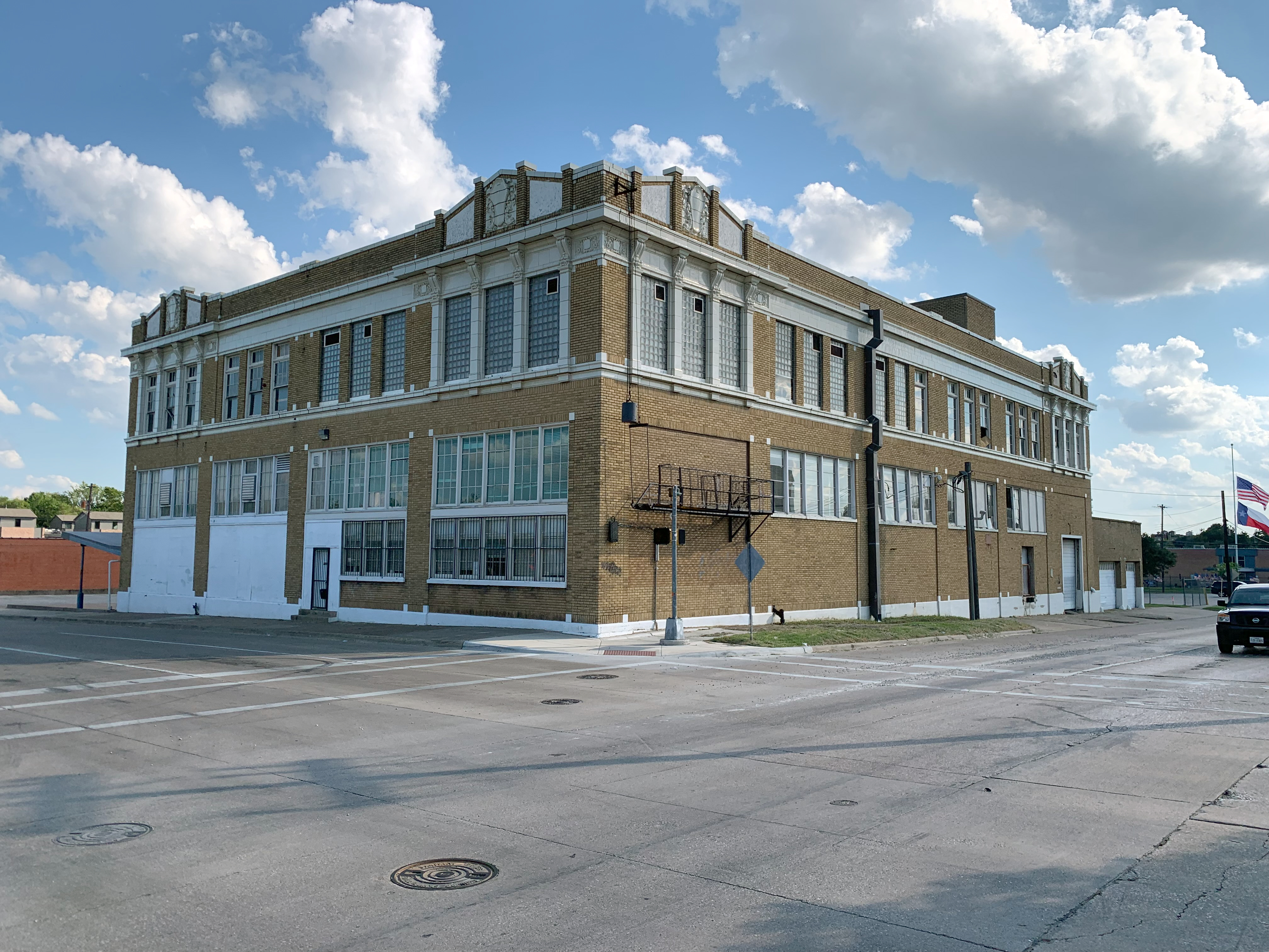 An exterior photo of The Boedeker building in Dallas Texas located at 1201 S. Ervay Street. A three story brick building built in 1922, it will be the future home of The Cedars Union.